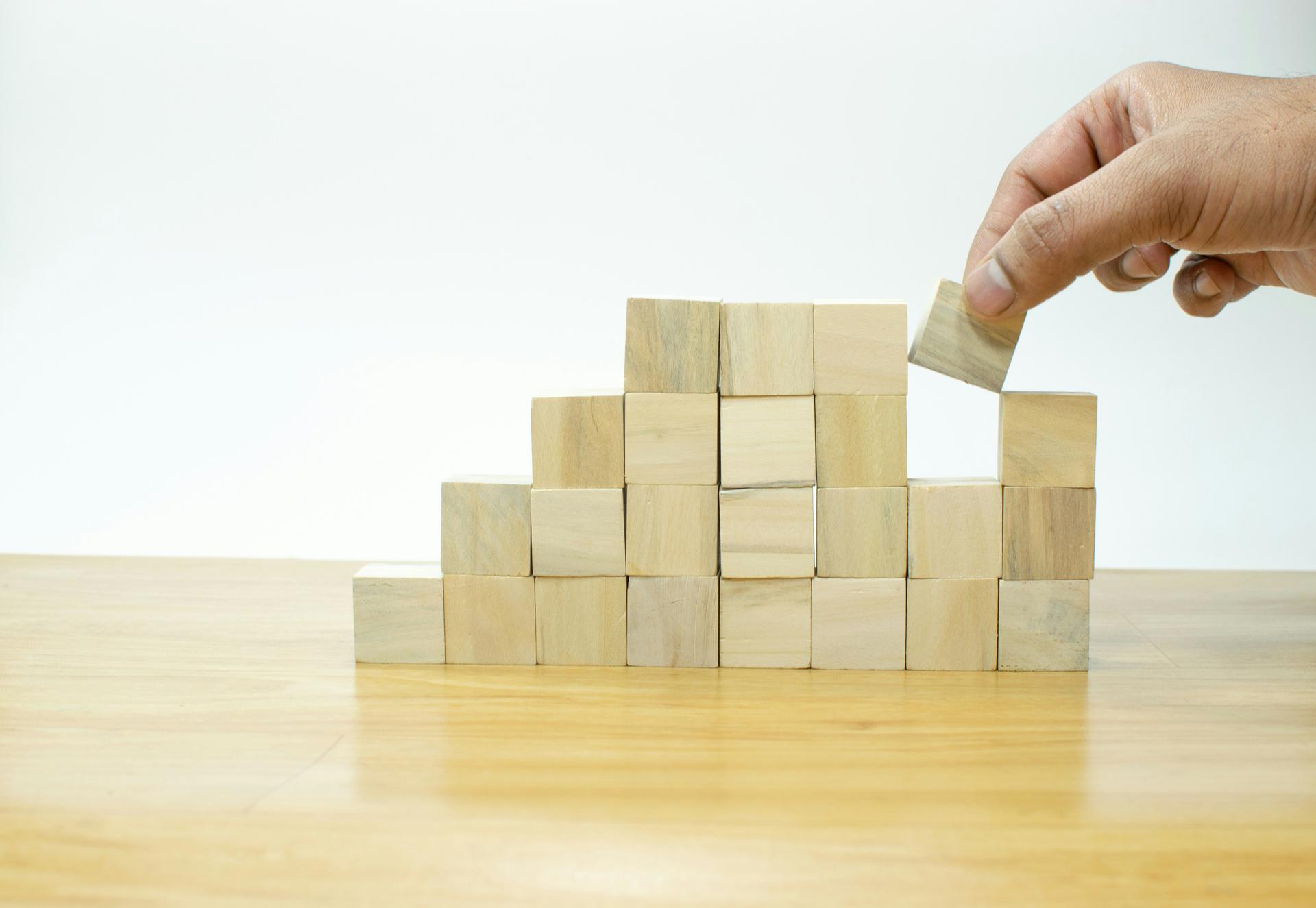 Hand stacking wooden planning blocks